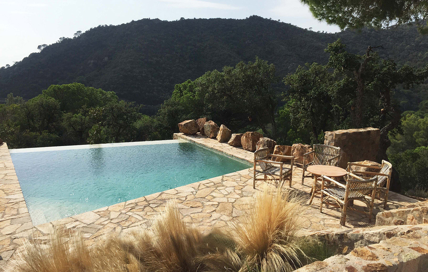 A luxury infinity pool in landscaped garden in Tossa de Mar Costa Brava