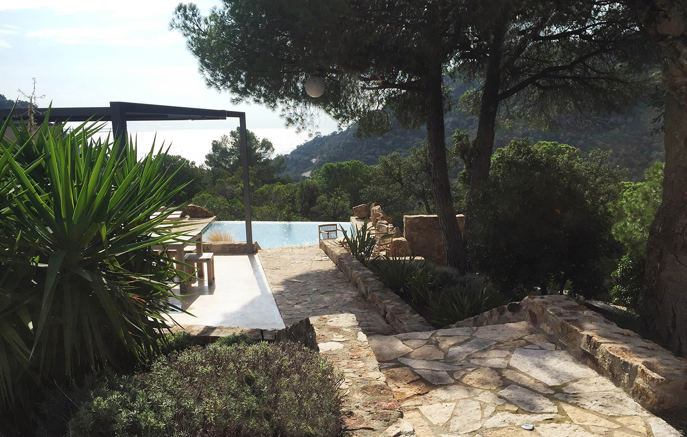 A stone pathway forms part of a landscaped garden in Tossa de Mar