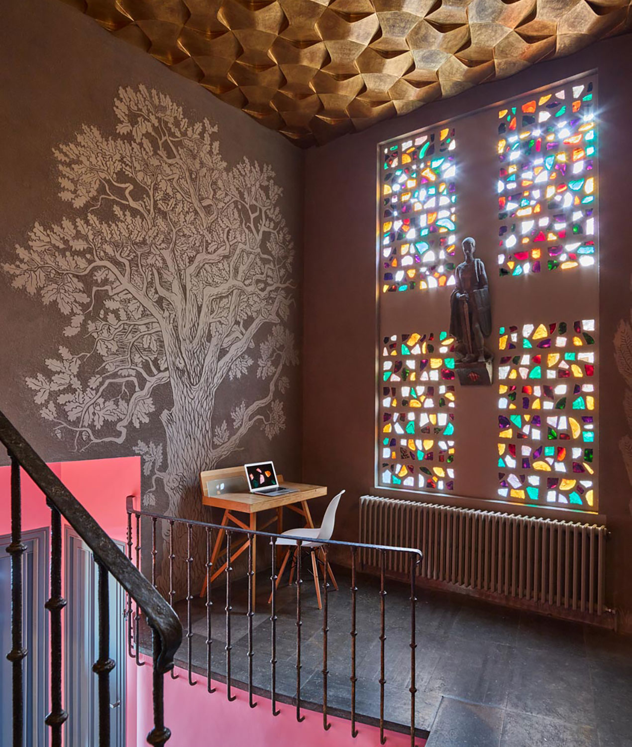 Casa creueta colourful entrance hall with stained glass windows and etched wall art