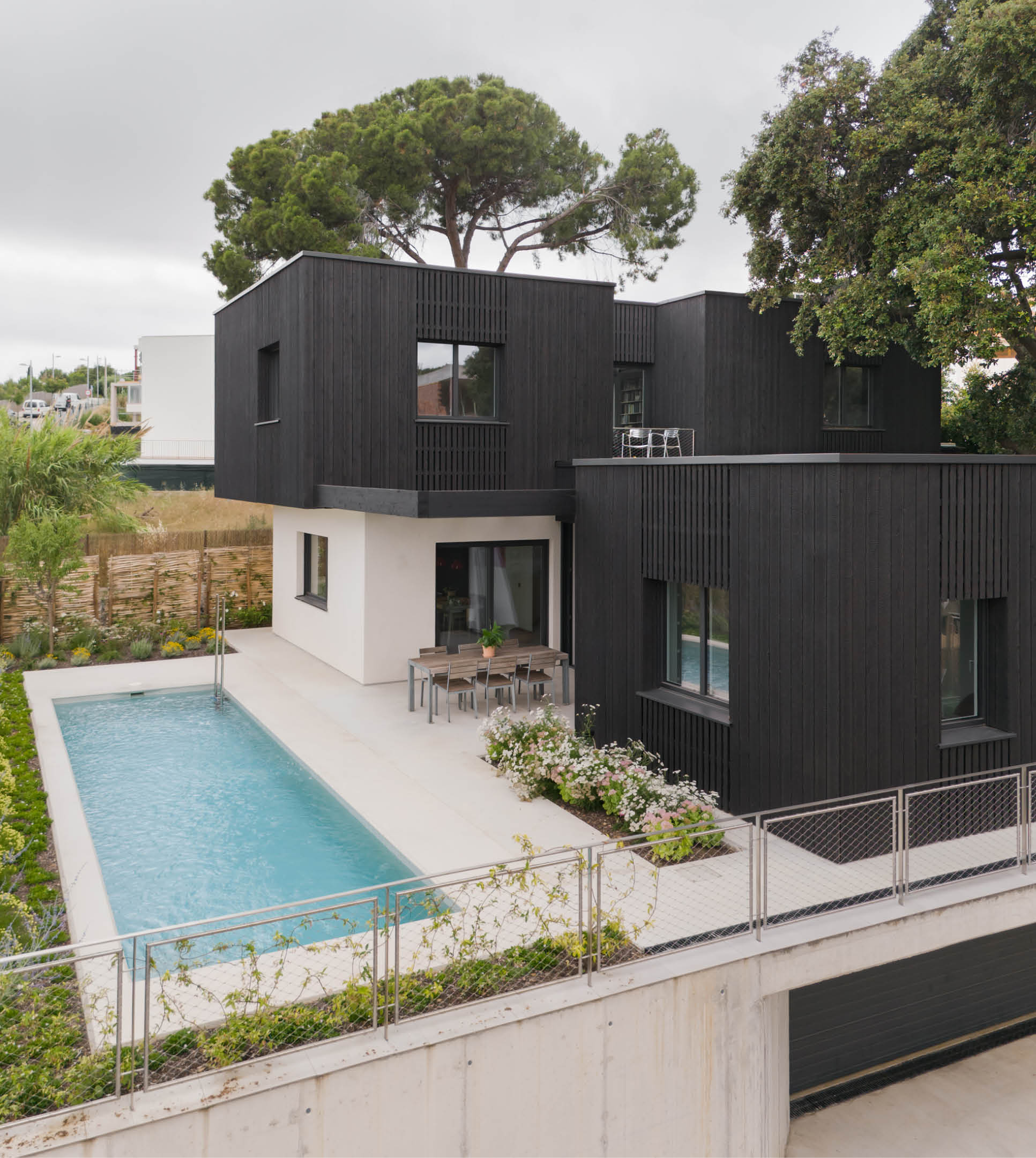 Exterior of a low-energy timber house in Spain with black charred cypress façade